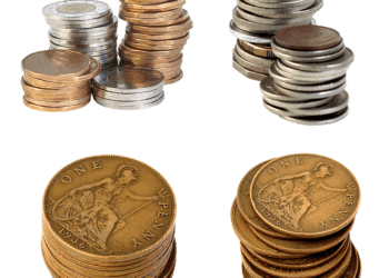 Stacks of various coins including British pennies in silver, copper, and bronze tones.