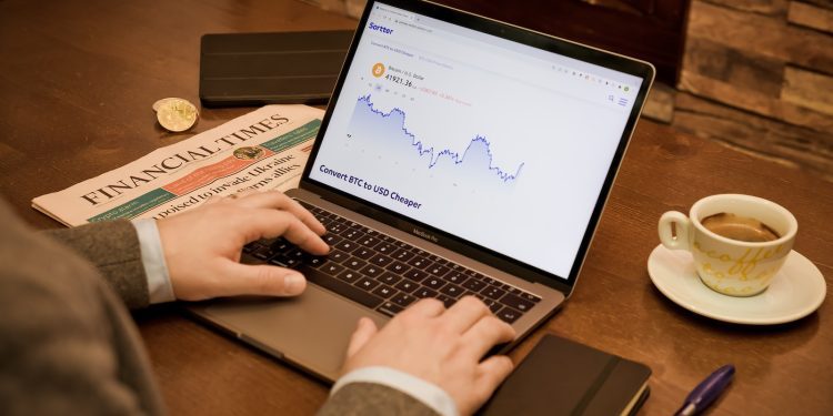 a person typing on a laptop on a table