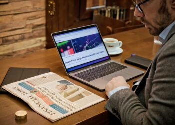 a man sitting at a desk with a laptop computer