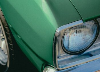 Green classic car headlight detail.