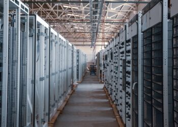 brown wooden hallway with gray metal doors