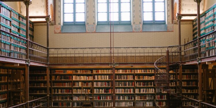 Grand library interior with tall bookshelves and arched windows