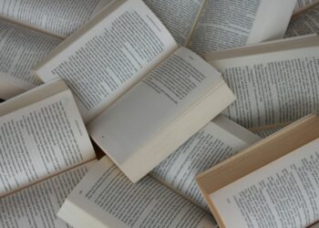 white and brown book on brown woven surface