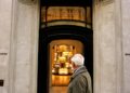 A man walking past a gucci store