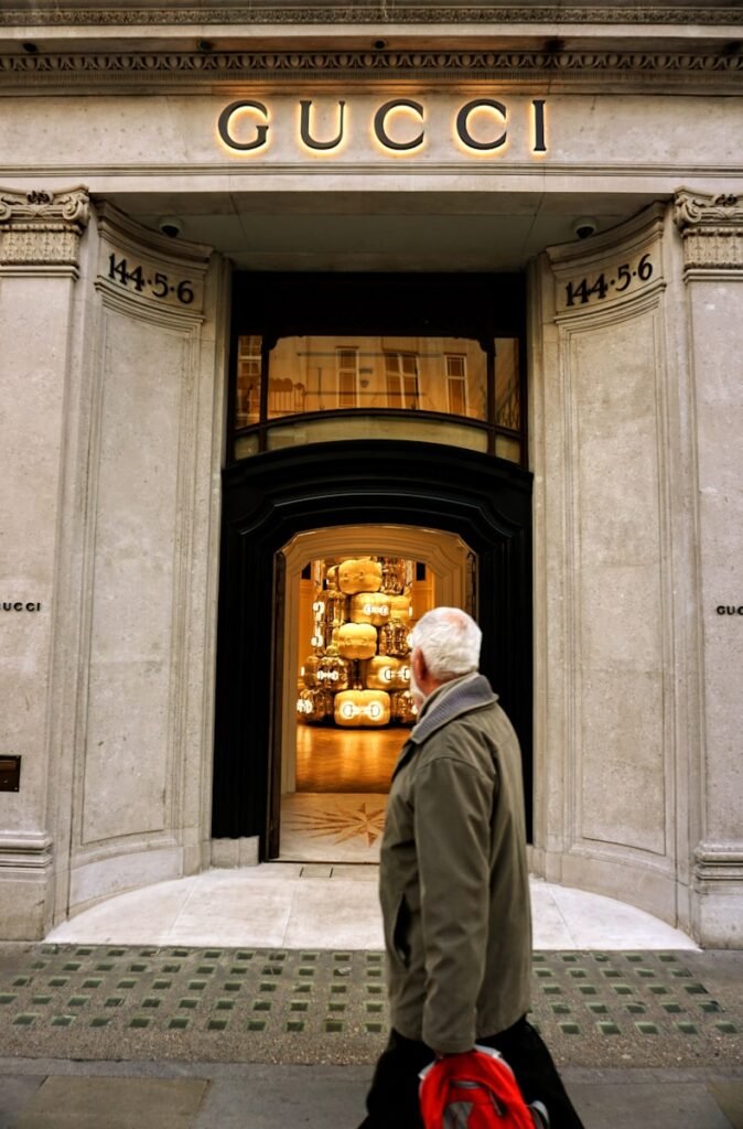 A man walking past a gucci store