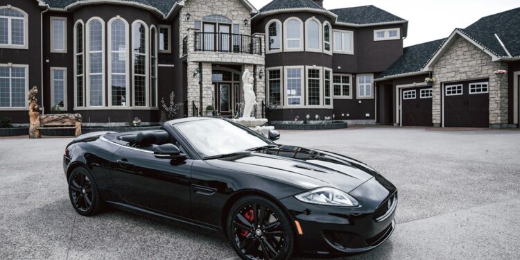 black convertible coupe parked near house