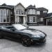 black convertible coupe parked near house