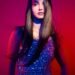 Woman in sequined dress with dramatic lighting