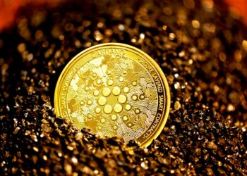 gold round coin on black surface