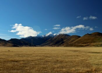 photo of grass field and mountains