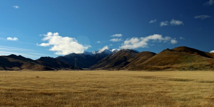 photo of grass field and mountains