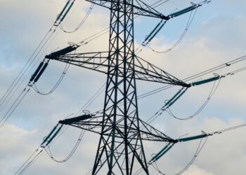 a tall metal tower with lots of wires on top of it