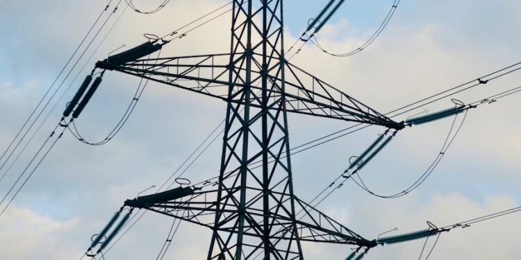 a tall metal tower with lots of wires on top of it